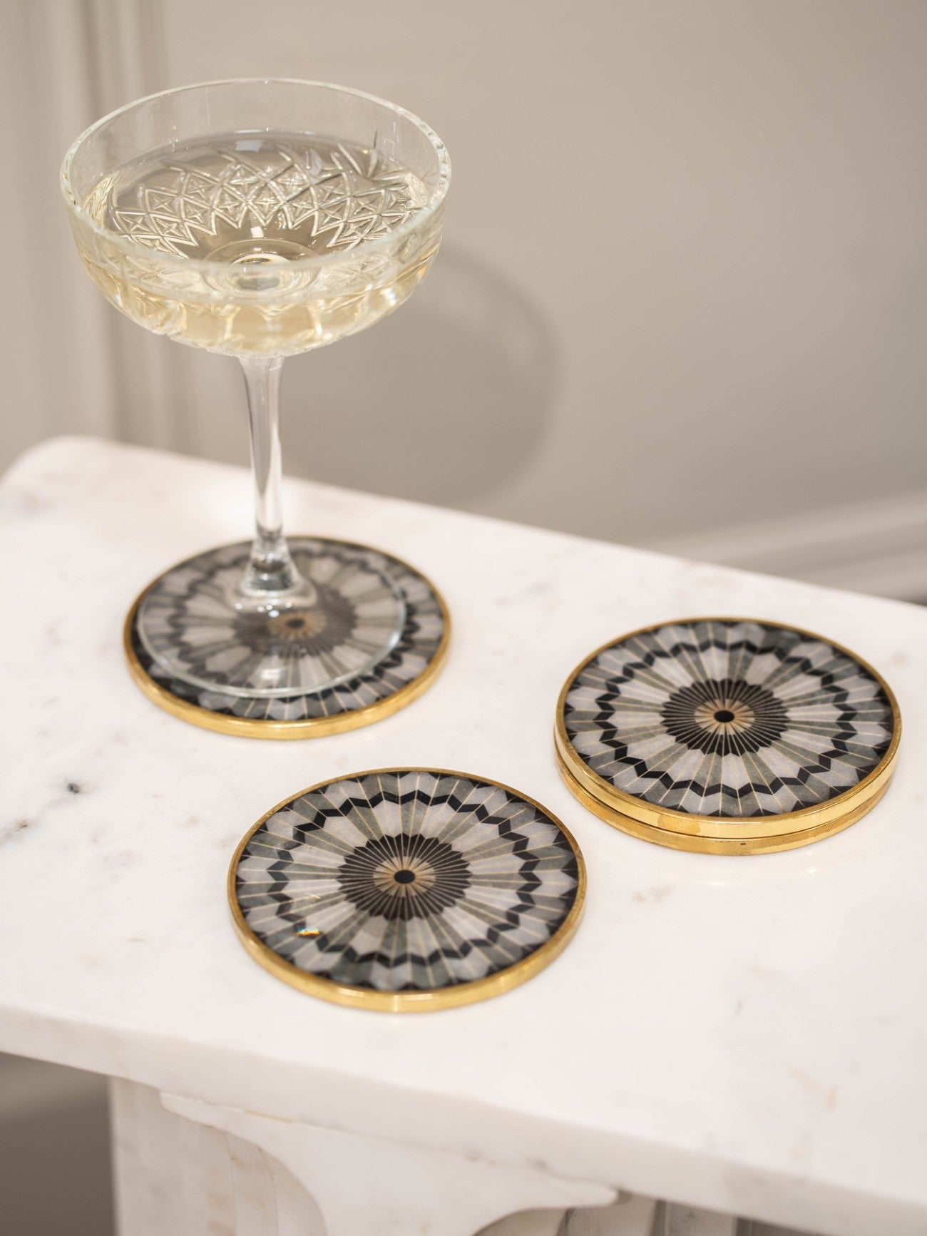 Set of 4 Black Circular Design Grey & Gold Coasters lifestyle