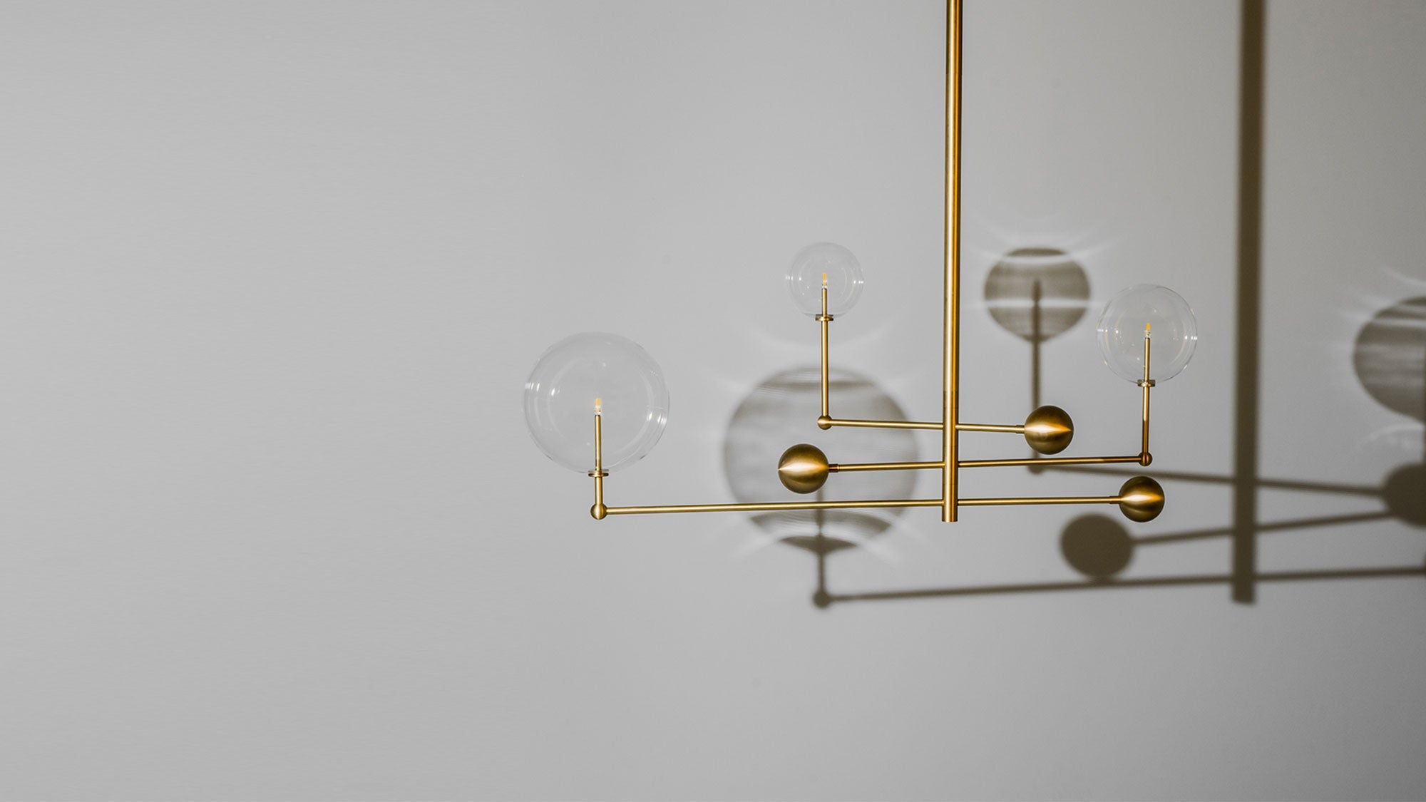 Schwung Universe Burnished Brass Transparent Globe Chandelier