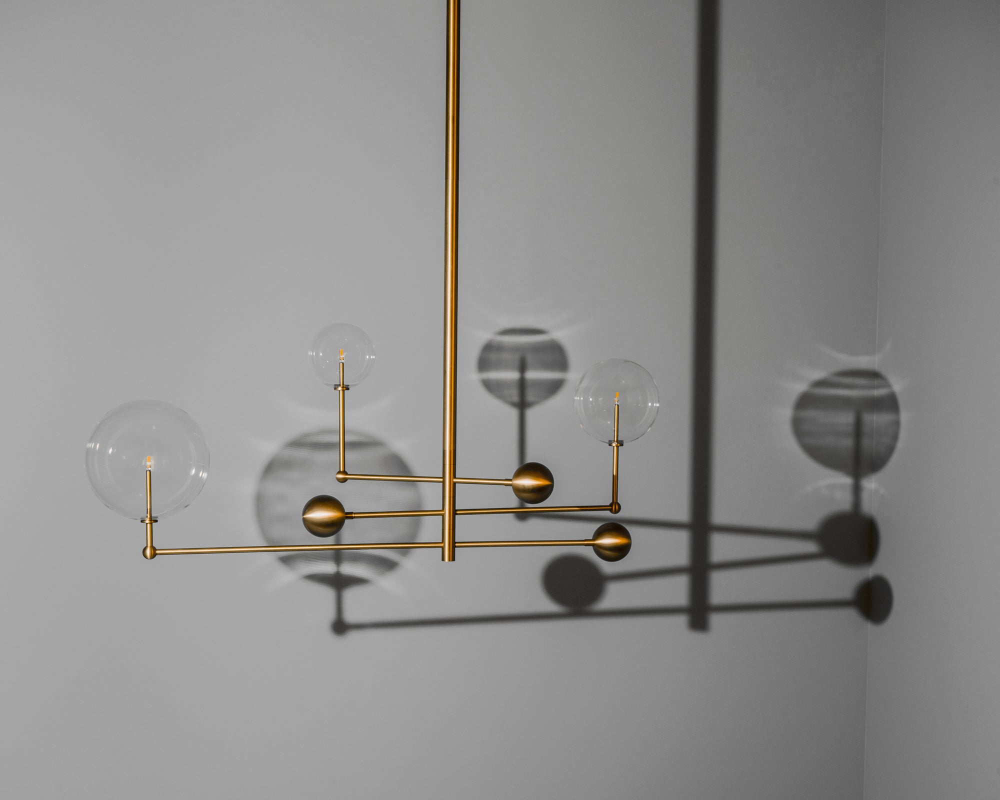 Schwung Universe Burnished Brass Transparent Globe Chandelier
