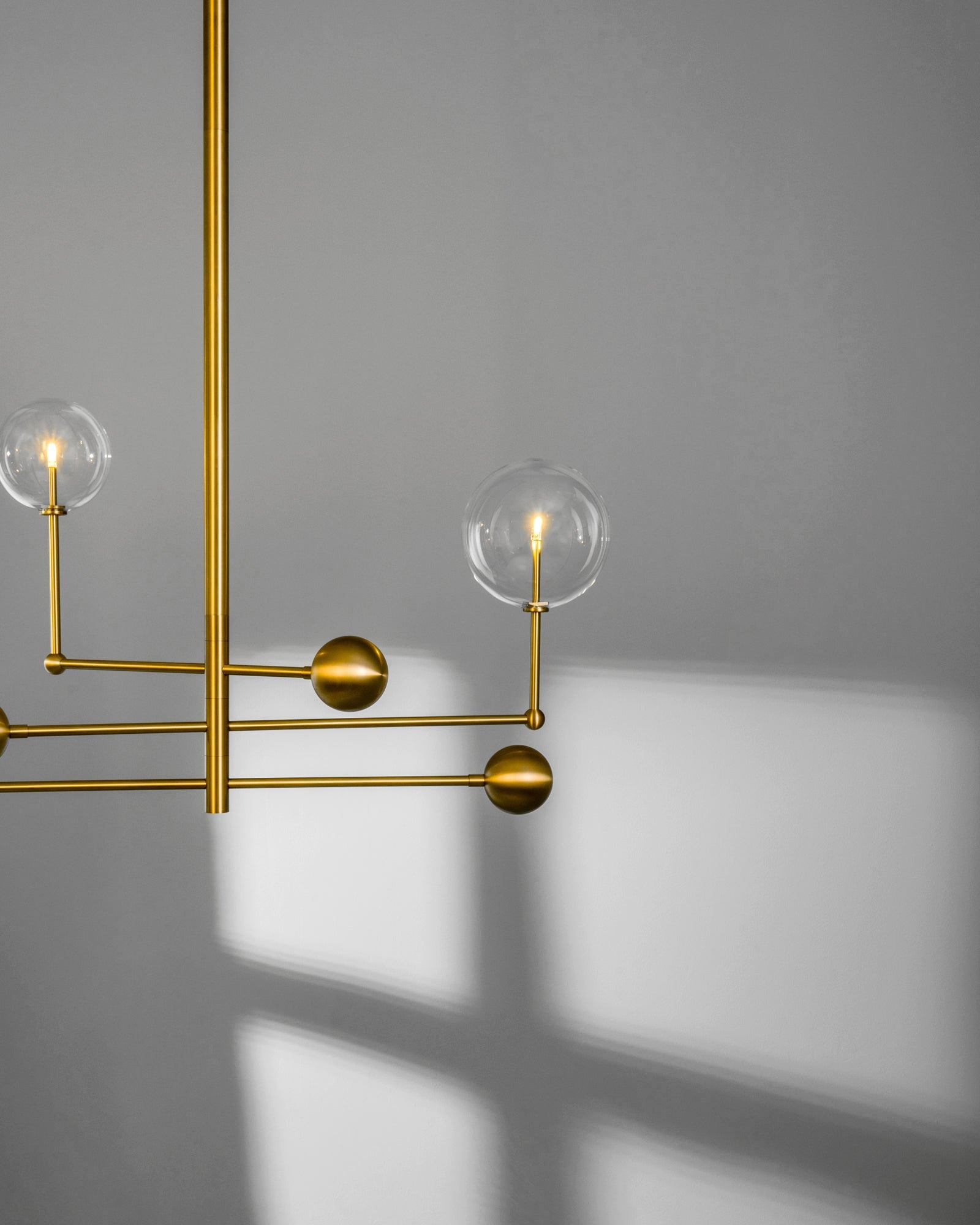 Schwung Universe Burnished Brass Transparent Globe Chandelier