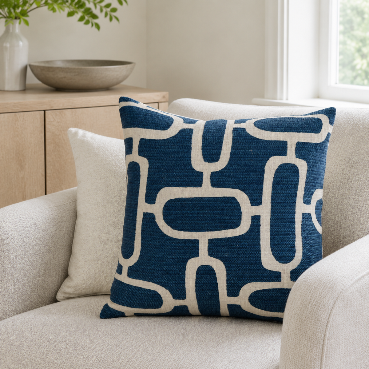 Malini Edison Abstract Chains Jacquard Blue Square Cushion 50x50 styled on light neutral furniture