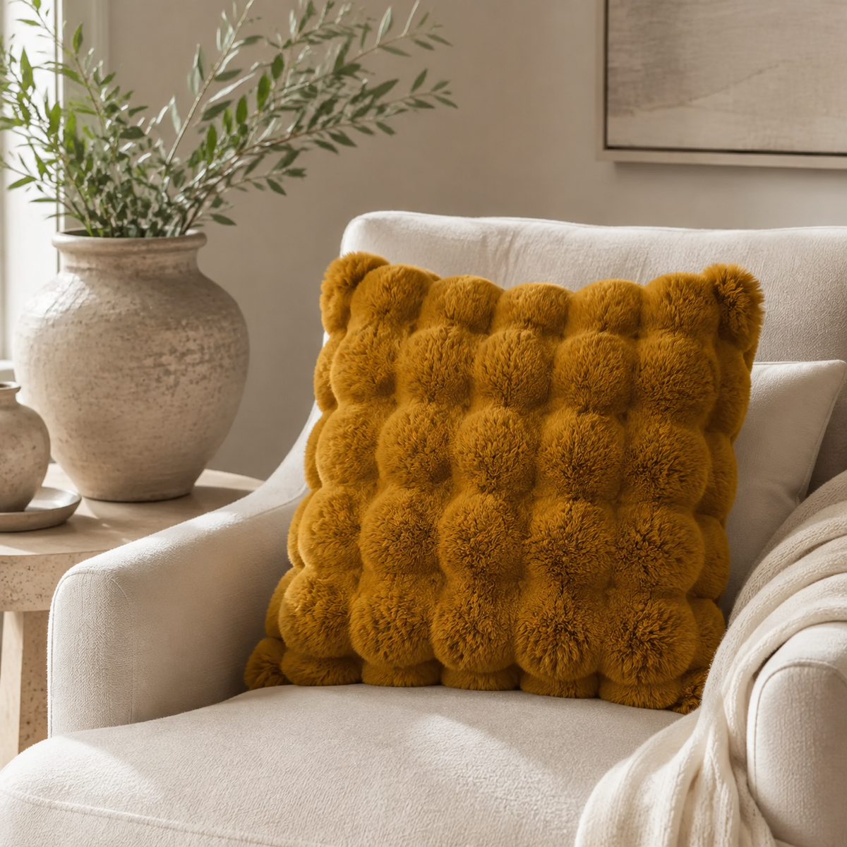 Malini Raffles whiskey brown faux fur 50x50 cushion styled on a light neutral armchair