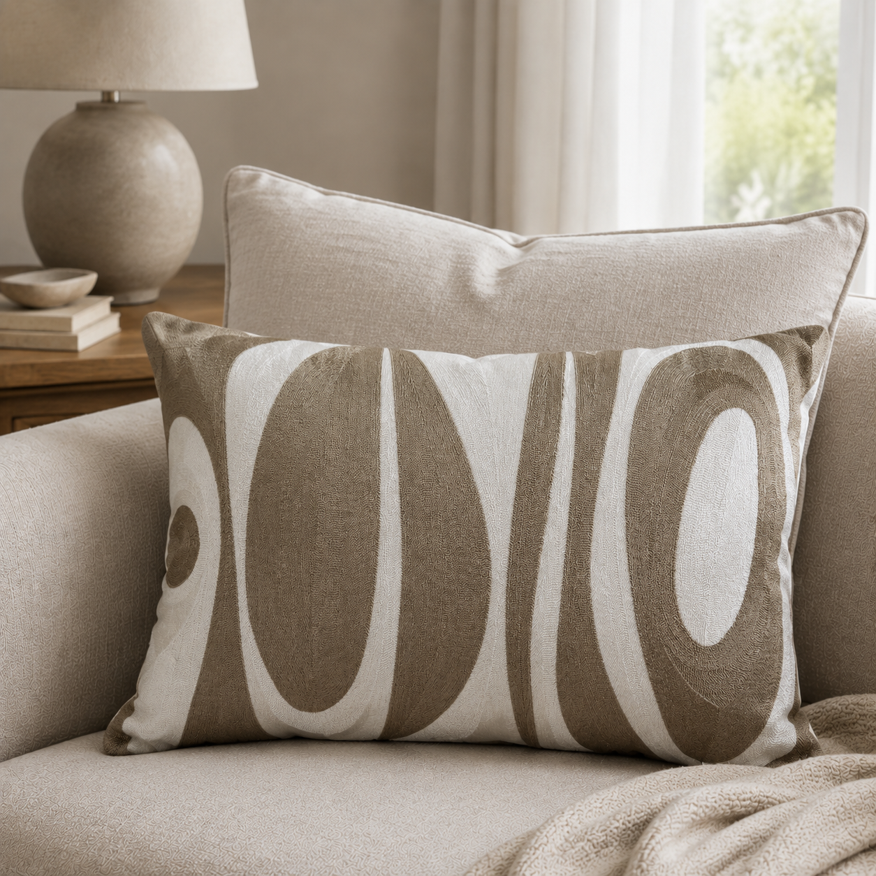 Malini Abstract Taupe Oval Emb On Cream Cushion 40x60 lifestyle image