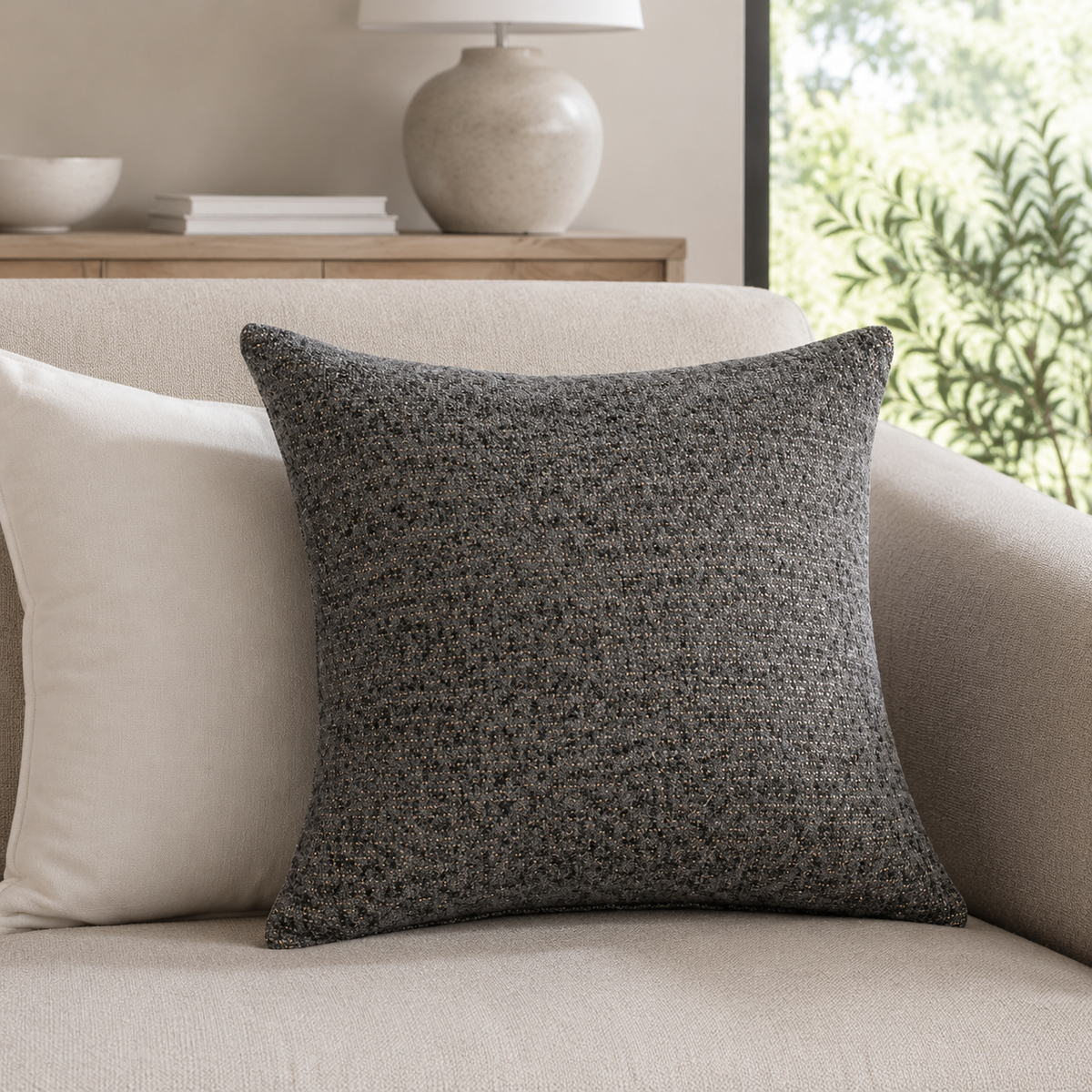Malini Flecks grey cushion with copper flecks 45x45 in a neutral living room