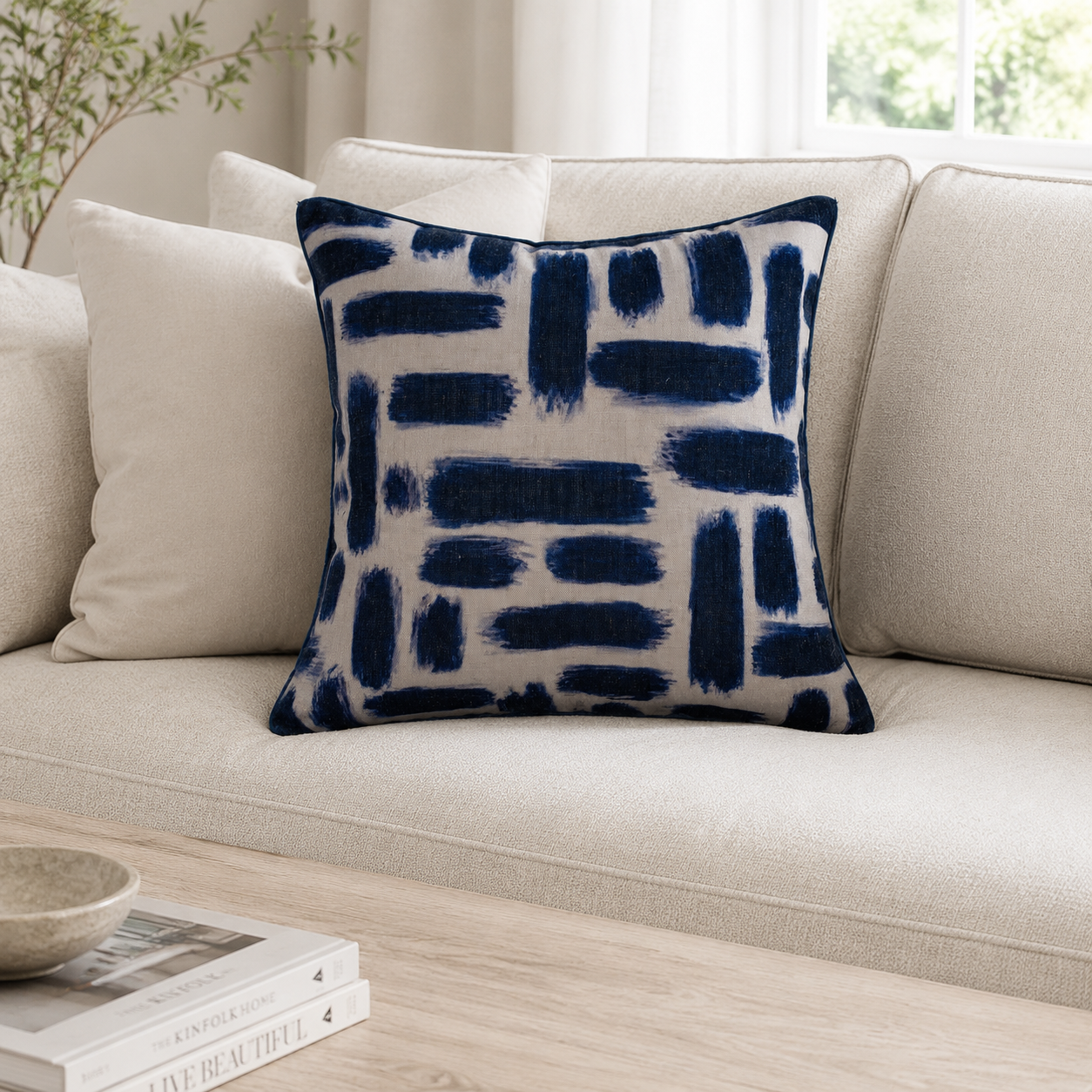 Malini Kentish Navy Abstract Square Cushion styled on a neutral sofa