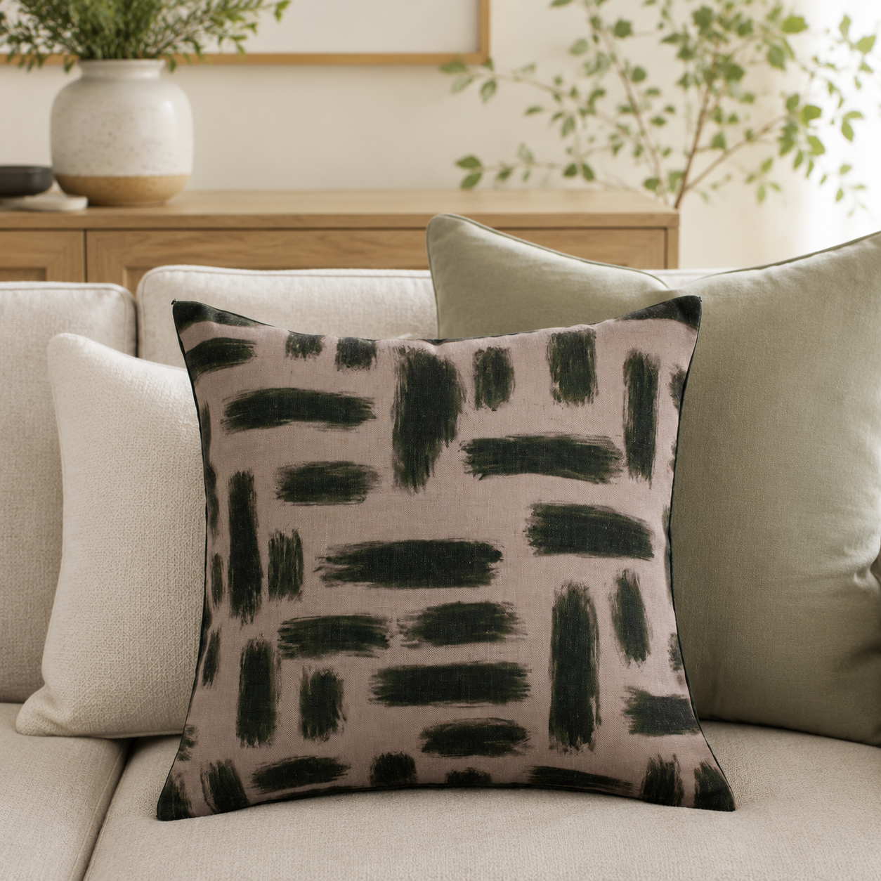 Malini Kentish Olive Green Abstract Square Cushion styled on a neutral sofa