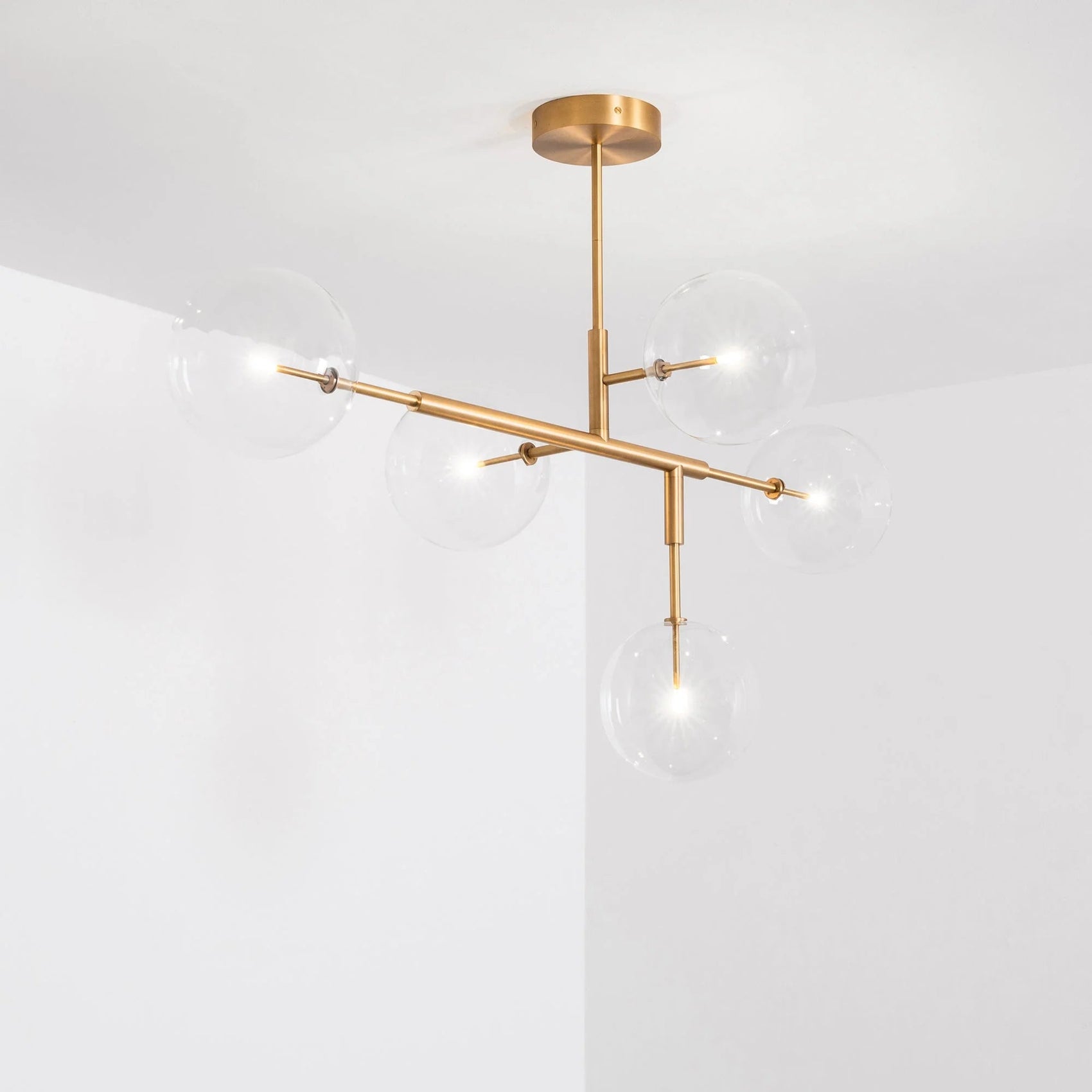Schwung Axis Burnished Brass Transparent Globe Ceiling Light