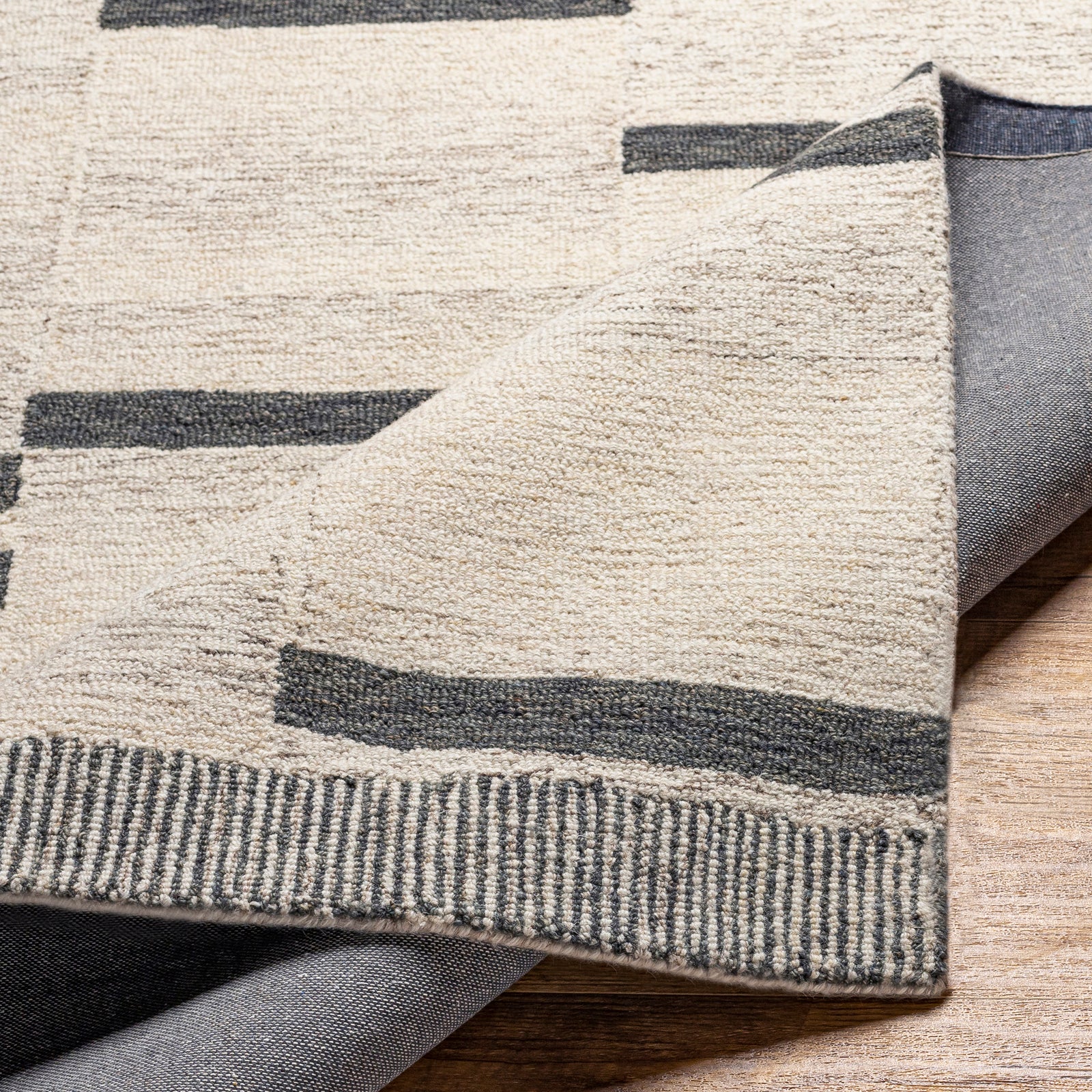Granada Global Hand Tufted Beige & Black Wool Rug 122x183cm - folded detail