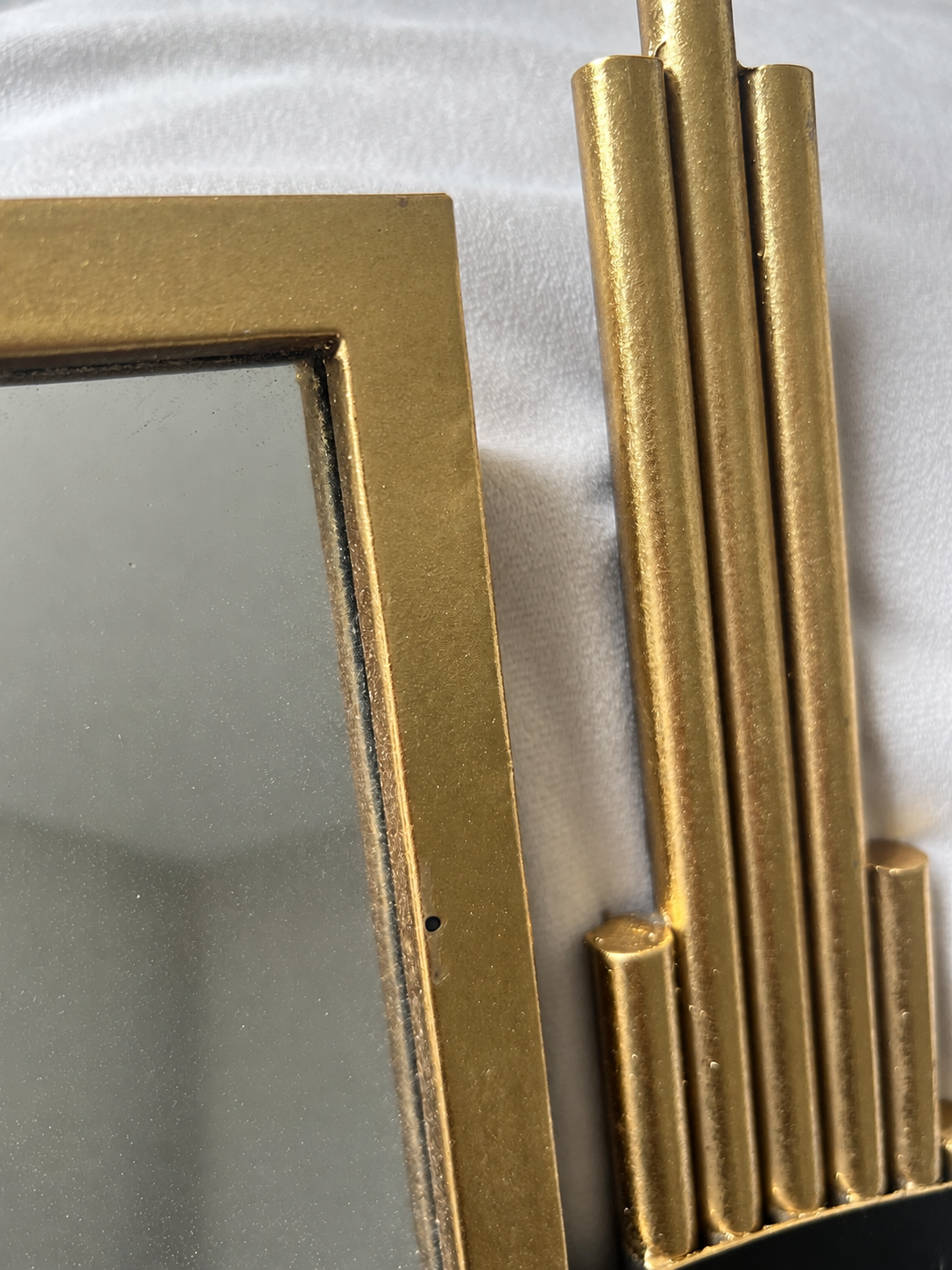 Close-up of the very small black dot on the frame. Photographer reflection removed.