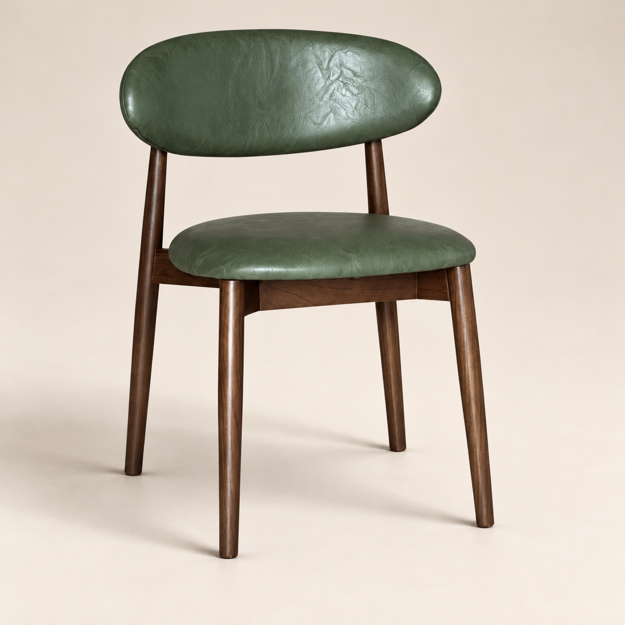 Elin Green Faux Leather Dark Oak Leg Dining Chair (Crib 5) on a warm neutral studio background