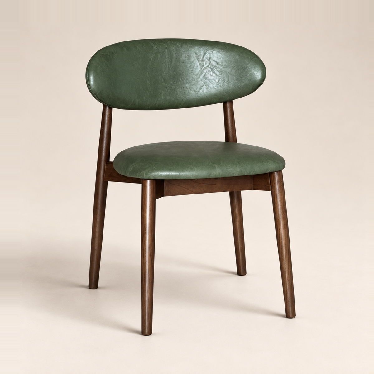 Elin Green Faux Leather Dark Oak Leg Dining Chair (Crib 5) on a warm neutral studio background