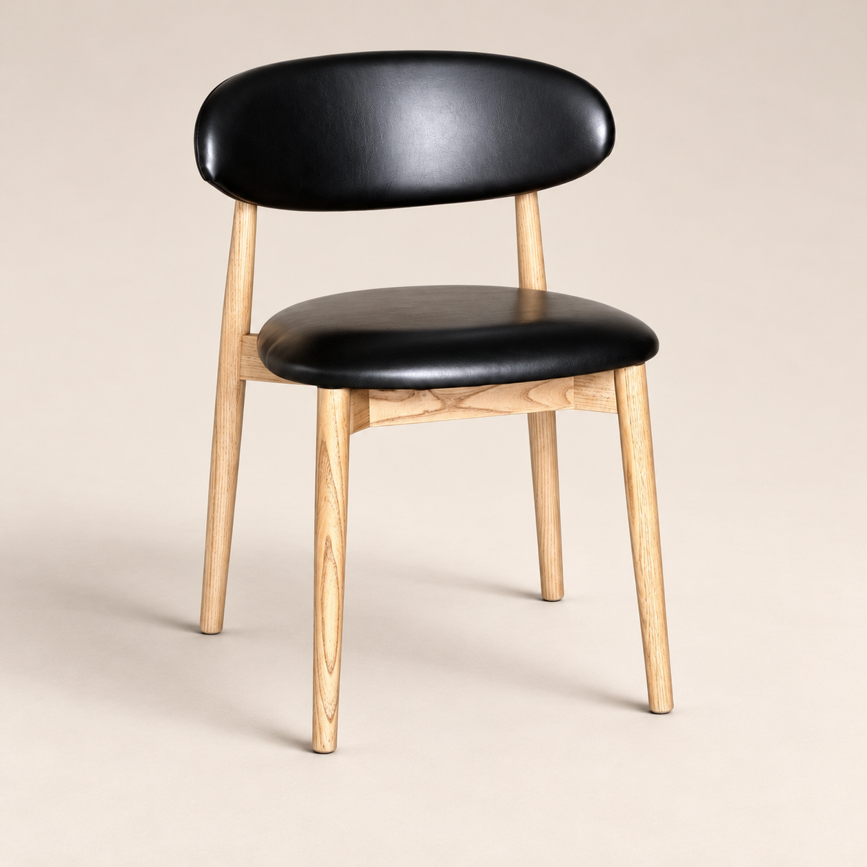 Elin Black Faux Leather Oak Dining Chair (Light Leg) on a warm neutral studio background