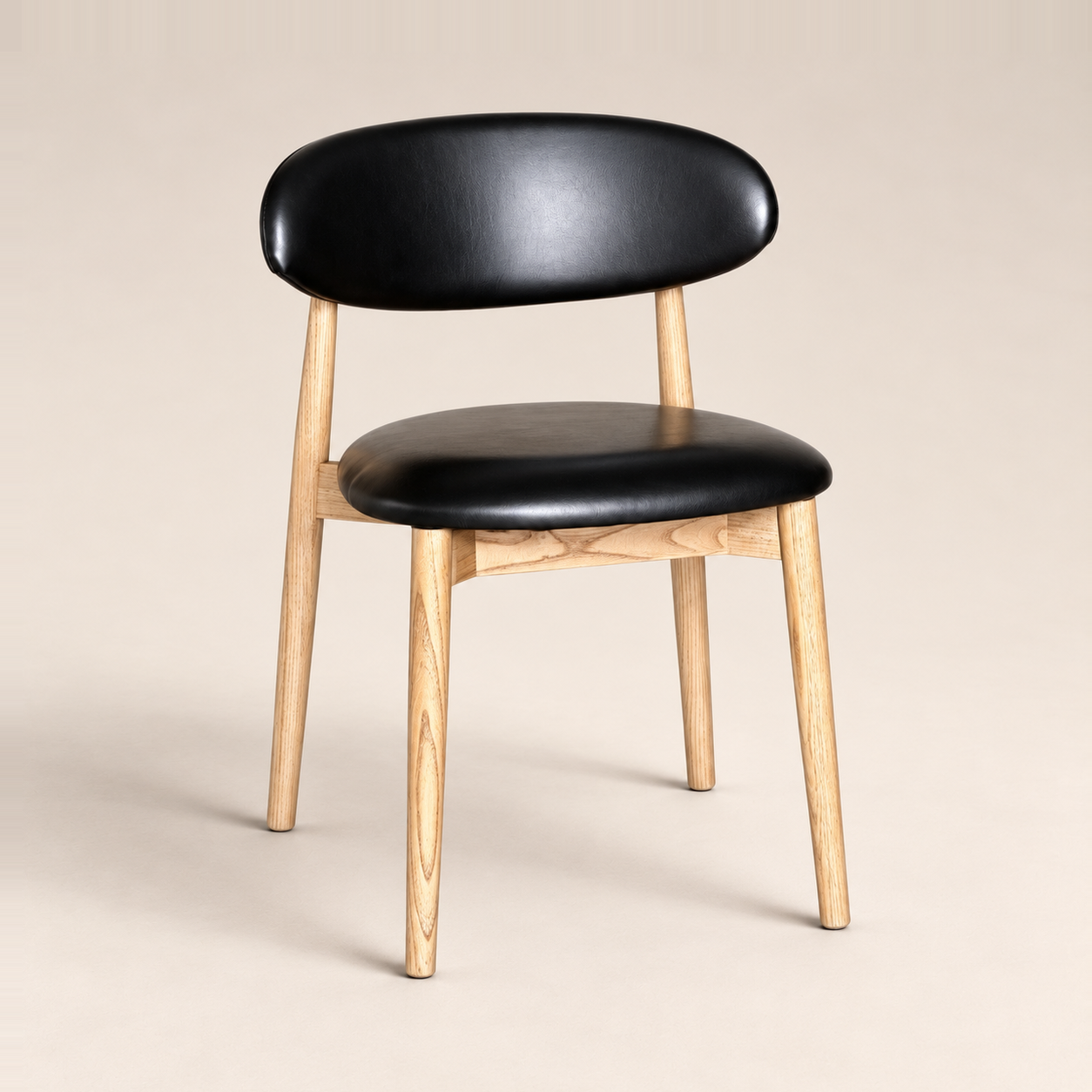 Elin Black Faux Leather Oak Dining Chair (Light Leg) on a warm neutral studio background