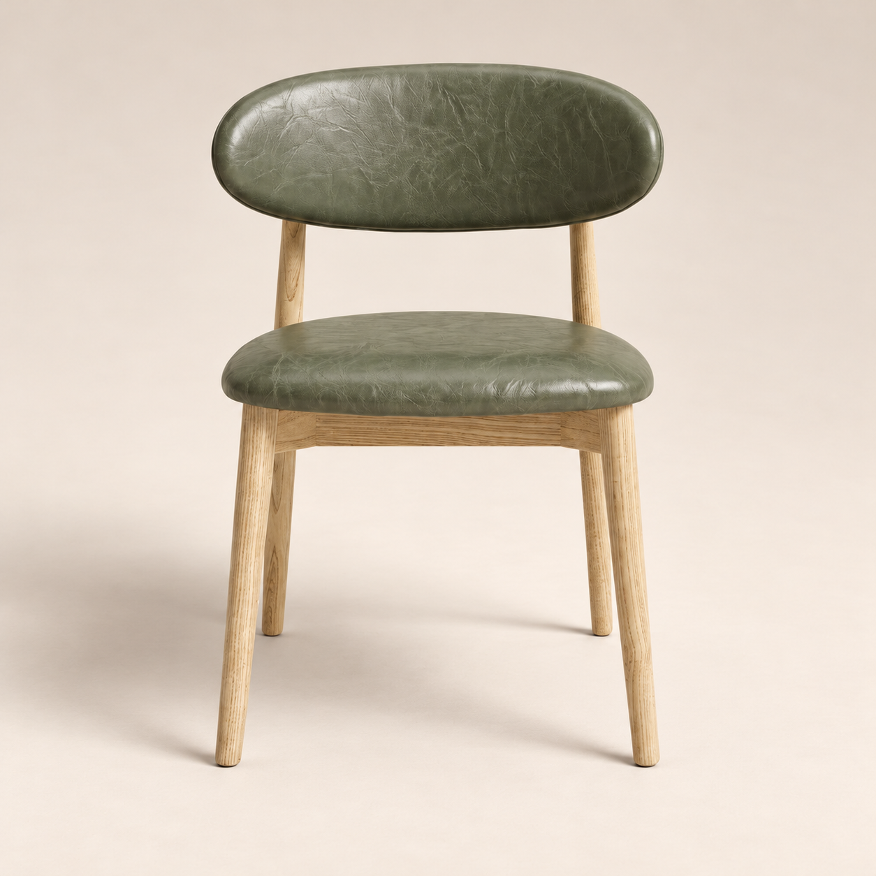 Elin Green Faux Leather Oak Dining Chair on a warm neutral studio background