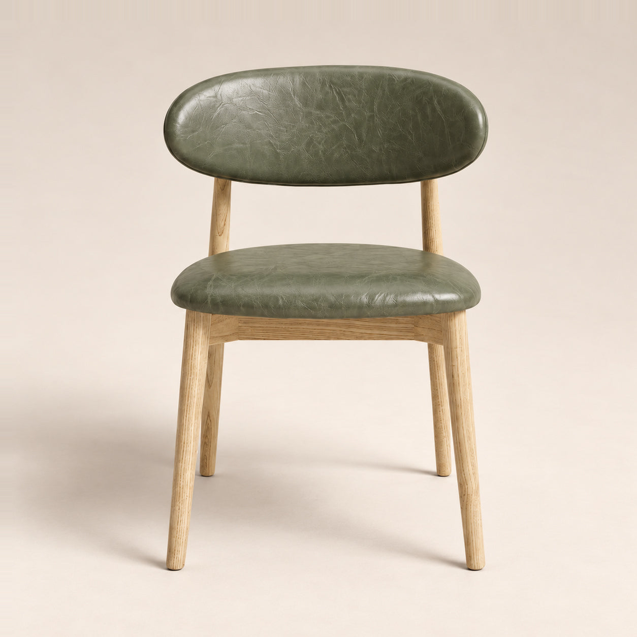 Elin Green Faux Leather Oak Dining Chair on a warm neutral studio background