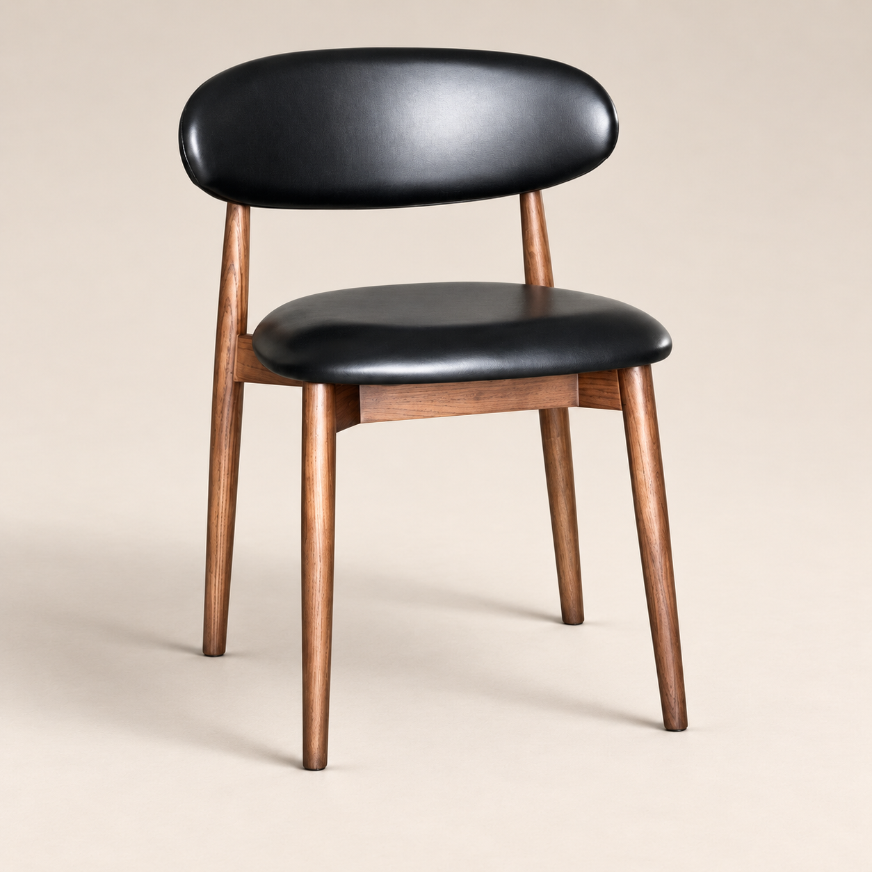 Elin Black Faux Leather Oak Dining Chair (Dark Leg) on a warm neutral studio background