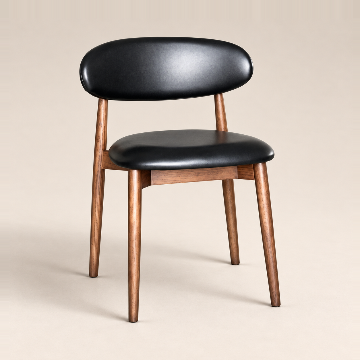 Elin Black Faux Leather Oak Dining Chair (Dark Leg) on a warm neutral studio background